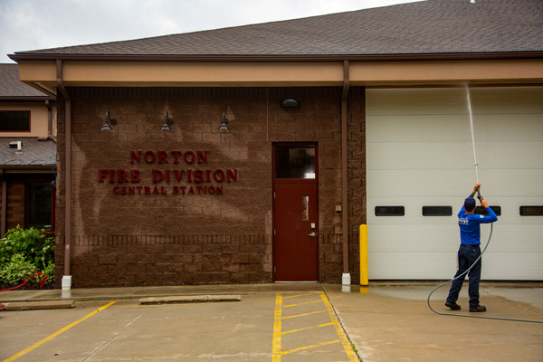 Member of Perfect Power Wash's Dream Team washing the exterior of the fire station in Norton, OH