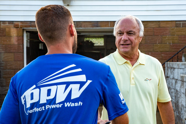 Perfect Power Wash technician greeting a customer at his home