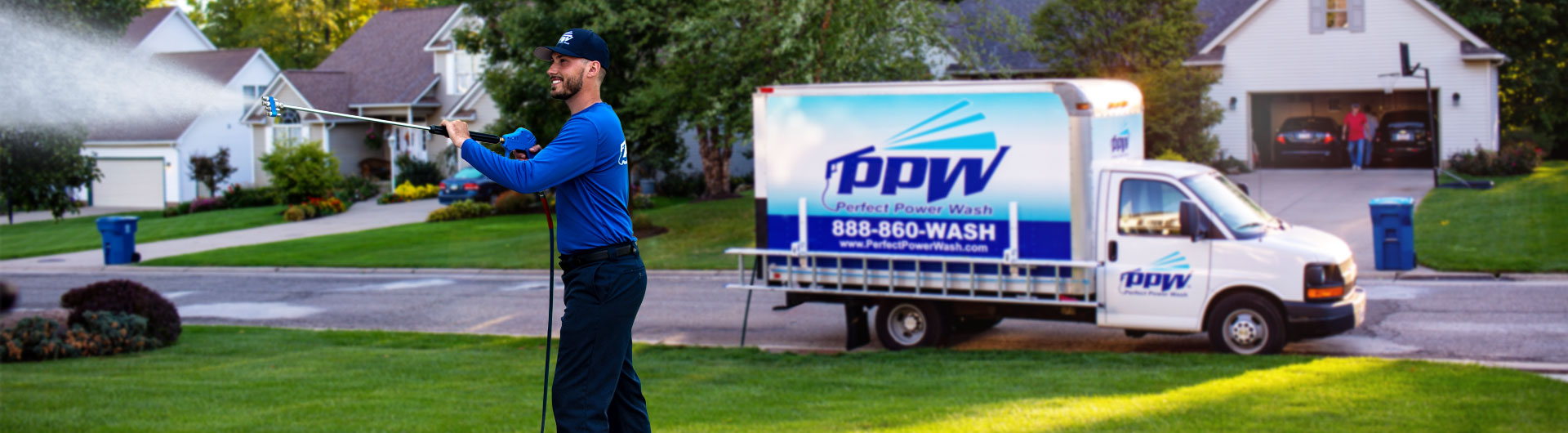 Photo of a Perfect Power Wash technician washing a house