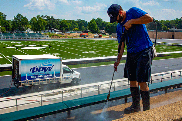 Perfect Power Wash technician power washes bleachers