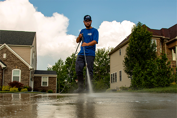 Perfect Power Wash employee power washing concrete