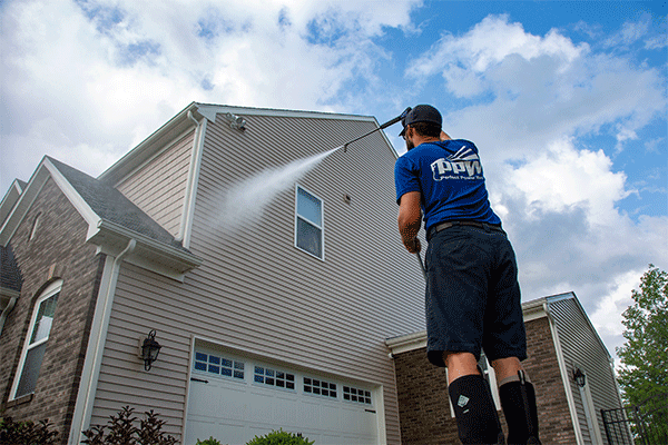 Perfect Power Wash technician power washing siding