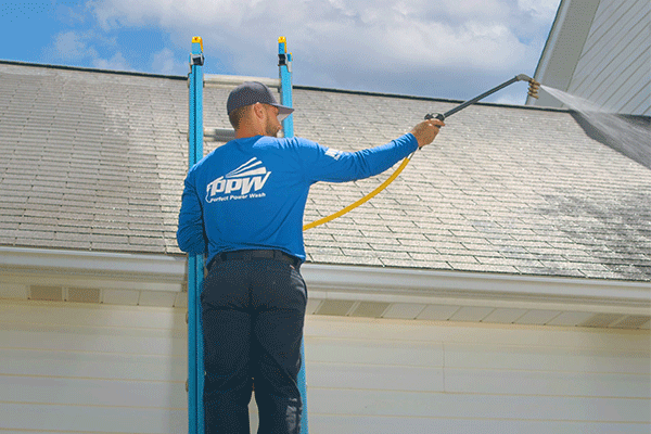 Perfect Power Wash technician performing a roof treatment