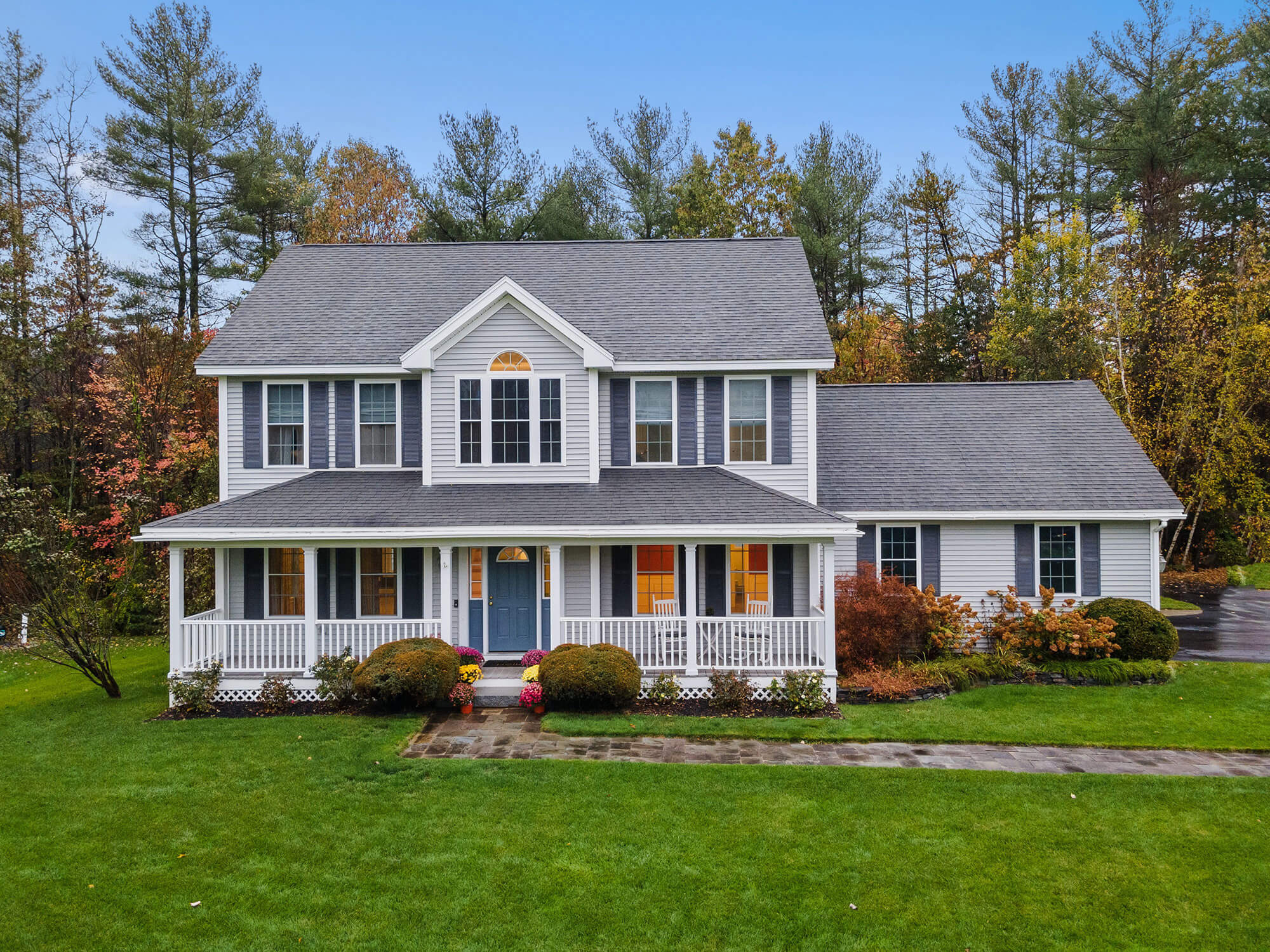 A 2 story home with a green lawn