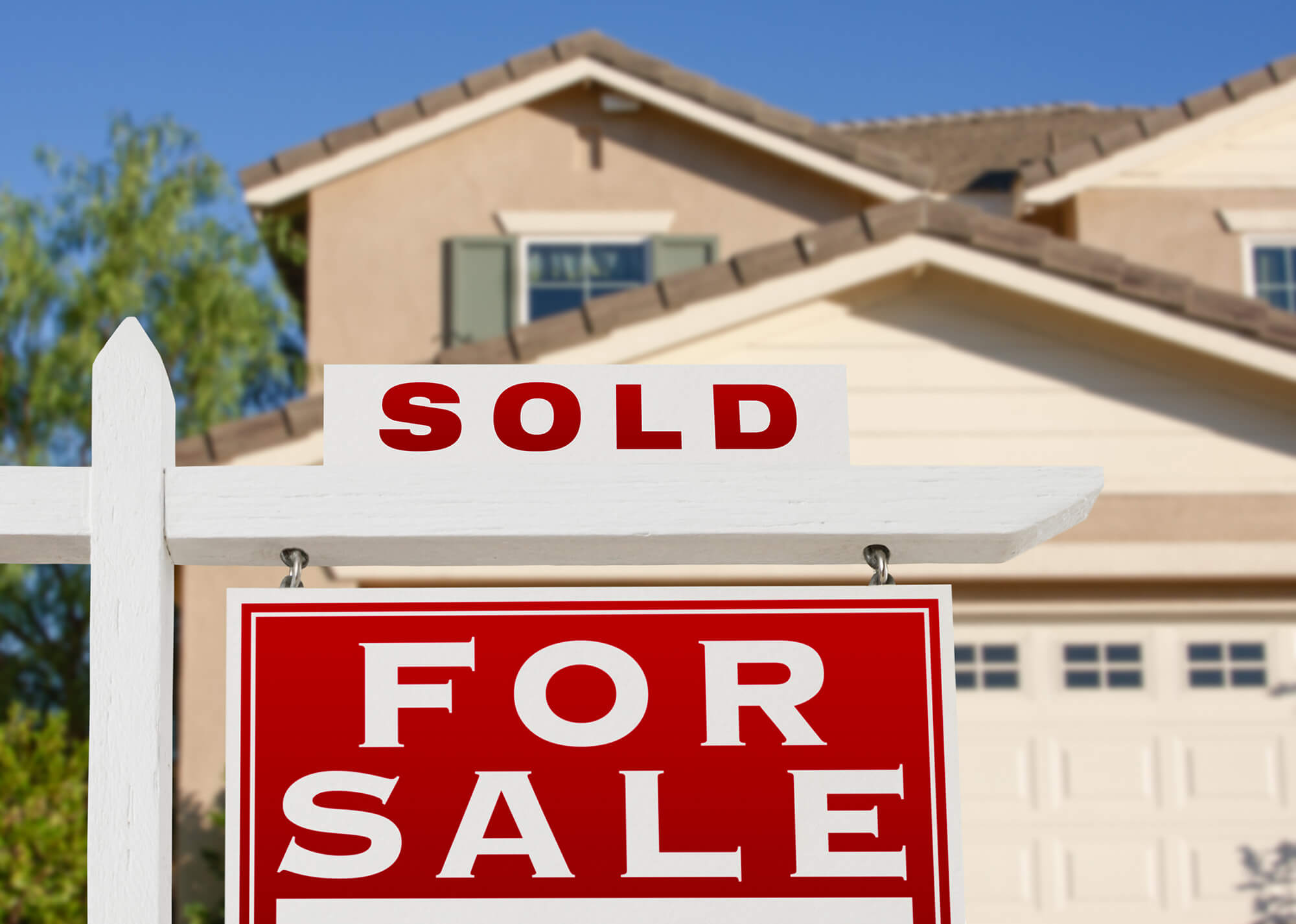 A sold sign in front of house